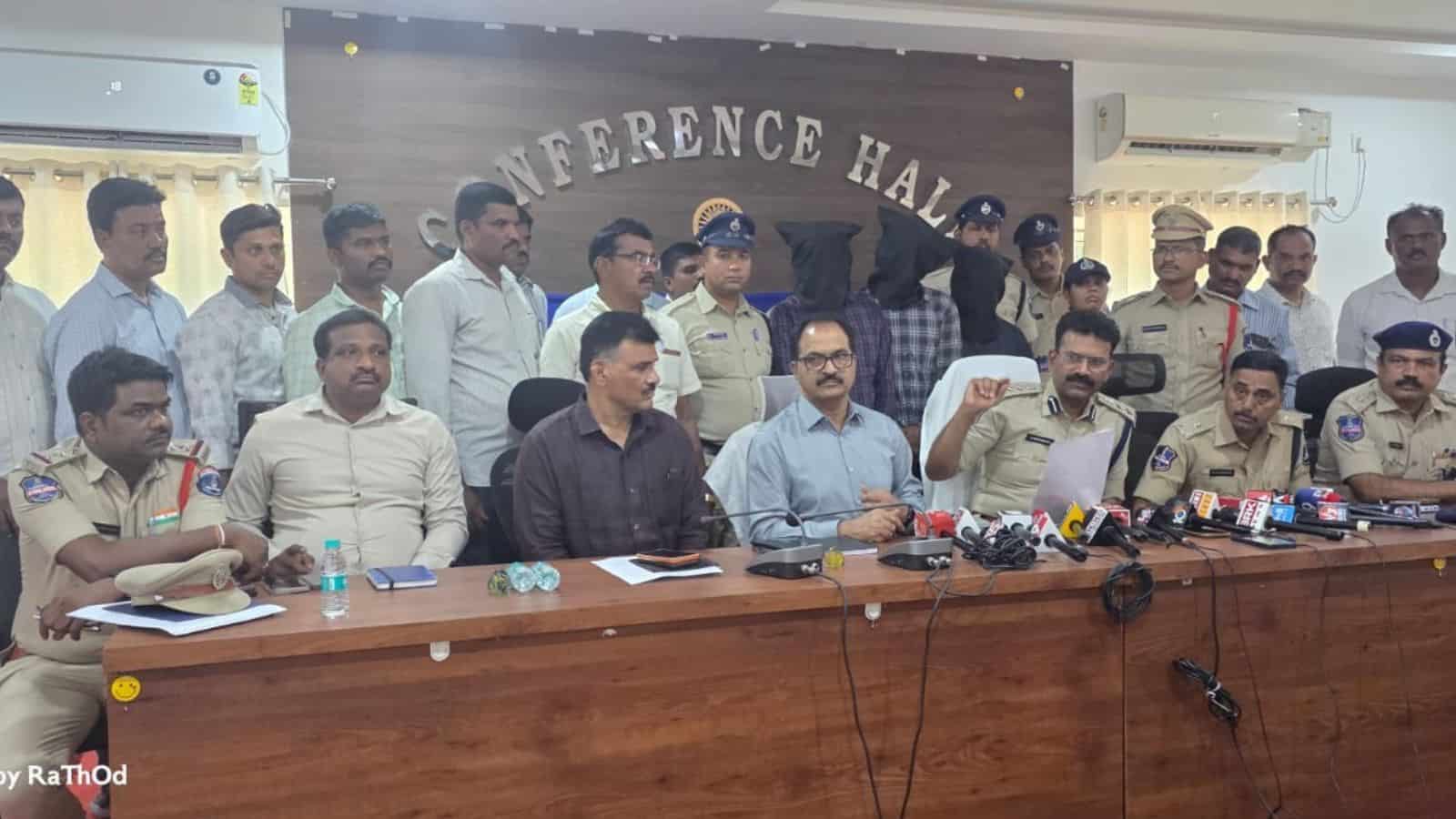 Police officials and government representatives seated at a conference table during a press briefing at t.
