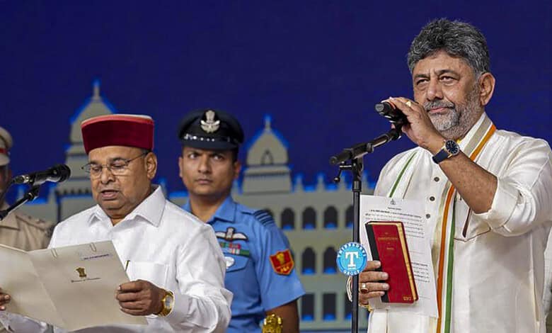 A man in traditional attire speaking at a podium with police officers in the background during a formal e.