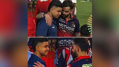 A young cricket player being congratulated by a teammate on the field after a match.