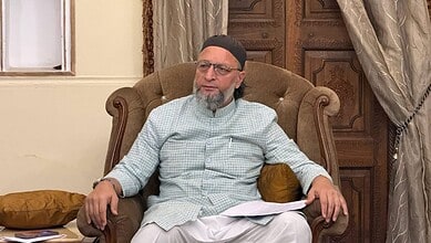 The Siasat Daily: Man in traditional attire sitting on an ornate armchair in a formal setting.