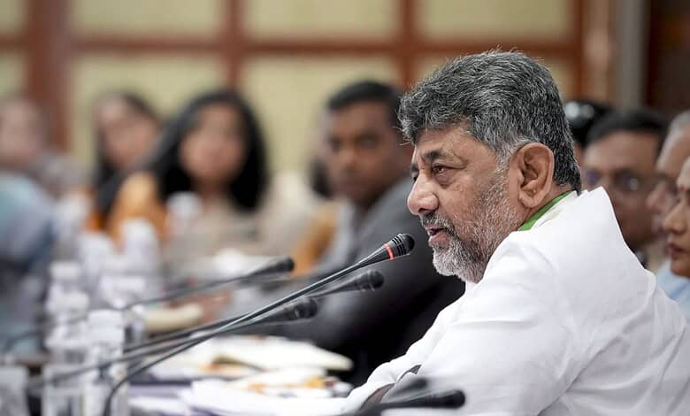 Senior man speaking at a conference with a microphone, surrounded by attentive participants in a formal s.