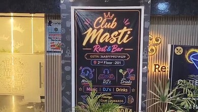 Vibrant nightclub sign for Club Masti Rest & Bar with music, DJ, drinks, and awards icons, located on the.