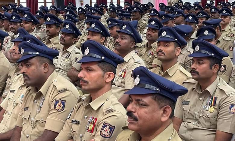 Police officers in uniform attending a formal event, standing in formation with serious expressions.