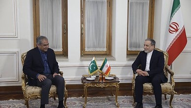 Diplomatic meeting between officials from Pakistan and Iran in an elegant room with national flags, discu.