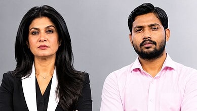 Empowered woman and confident man in professional attire posing for a business photo.