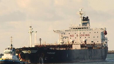 Oil tanker ship Theano sailing on water with a cloudy sky in the background.