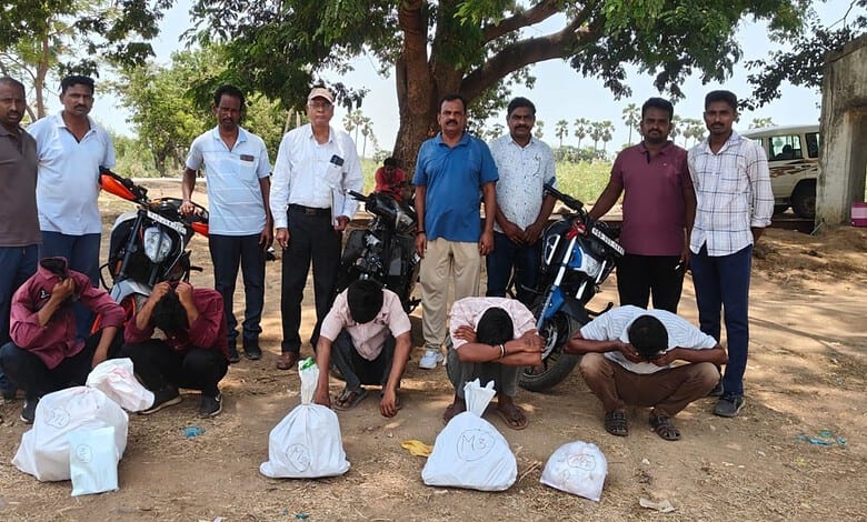 Group of men with motorcycles participating in a community cleanup event outdoors in a rural area.