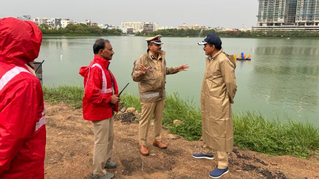 Local officials discussing environmental issues by a riverbank in an urban area, wearing casual and offic.