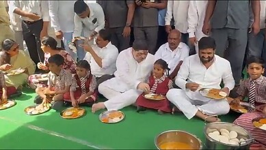 A man and children enjoying traditional food together at a cultural event.