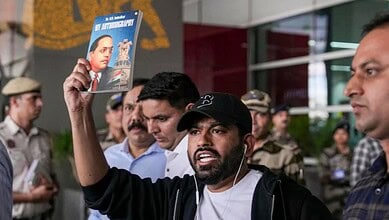 Protestor holding a magazine at a public demonstration in Rajasthan.
