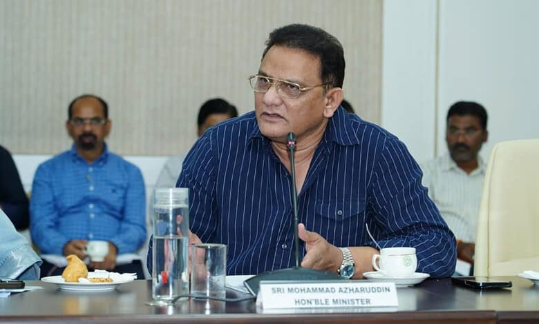 Honourable Minister Md. Azamuddin speaking at a formal meeting with colleagues.