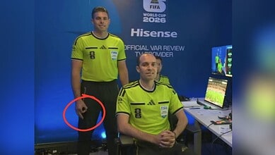 Referee with hand gesture during World Cup match, monitored for racism issues.