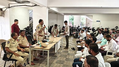 Police officials address a crowd at a function hall in Hyderabad about noise pollution rules.