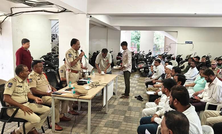 Police officials address a crowd at a function hall in Hyderabad about noise pollution rules.