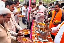 People participating in a religious event with offerings and prayers, celebrating a spiritual occasion.