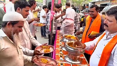 People participating in a religious event with offerings and prayers, celebrating a spiritual occasion.