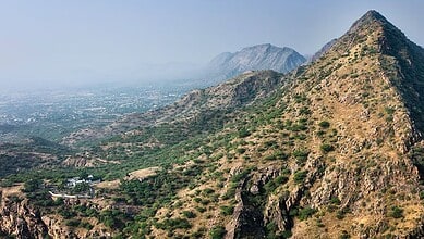 Scenic view of Aravalli hills with rugged terrain and sparse vegetation in India.