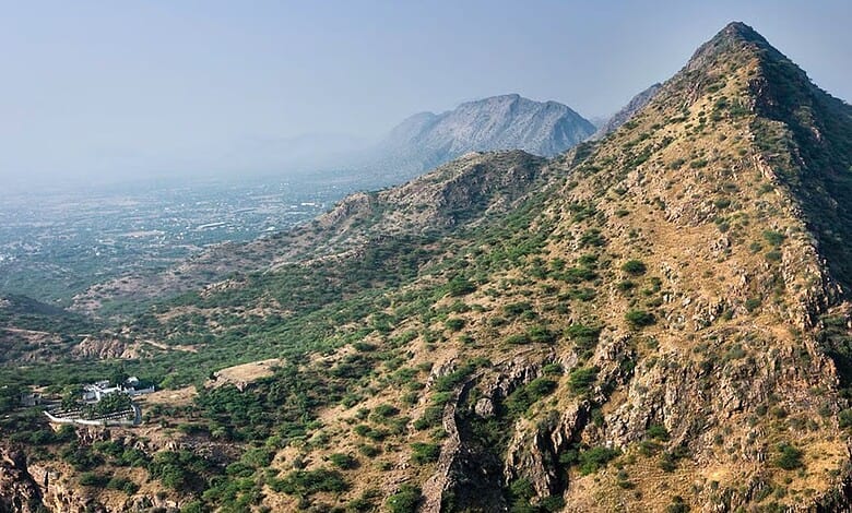Scenic view of Aravalli hills with rugged terrain and sparse vegetation in India.
