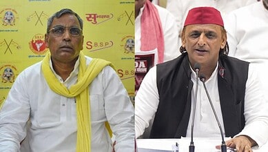 UP minister Rajbhar speaking at a press conference with a yellow background.