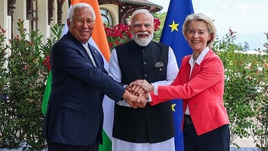 Indian Prime Minister Narendra Modi, European Union leader, and Indian official shake hands outdoors.