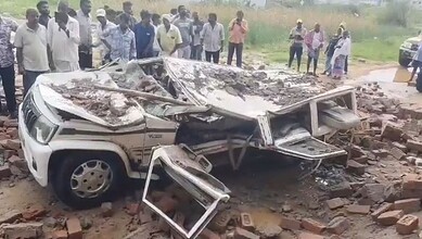 A mangled car after a wall collapses on it in Mahabubngar