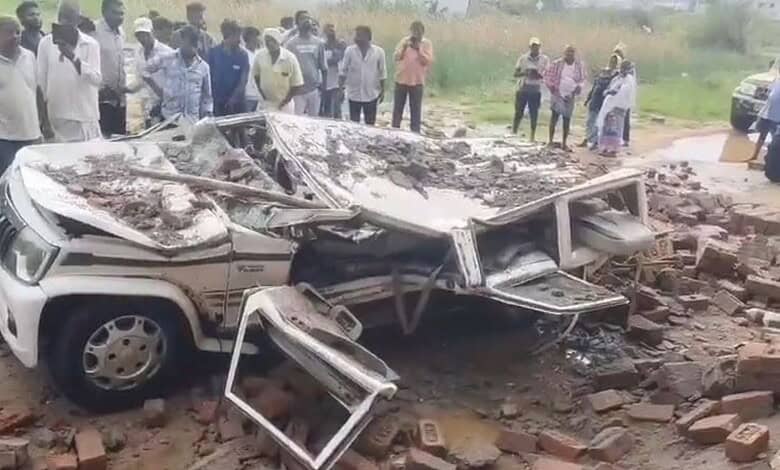 A mangled car after a wall collapses on it in Mahabubngar