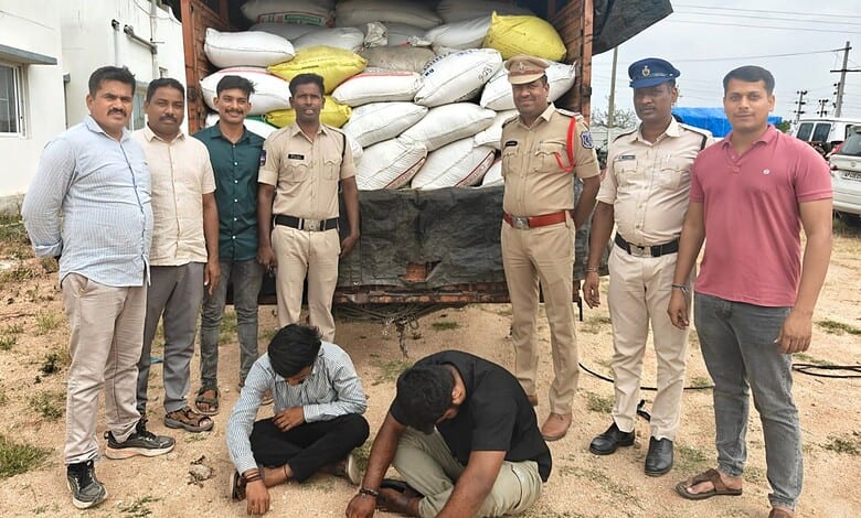 Group of men, including police officers, standing outdoors near a truck loaded with bags.