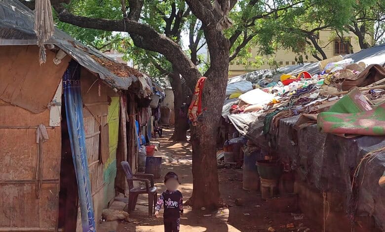 Rohingya children in Hyderabad amidst makeshift shelters and scattered belongings.