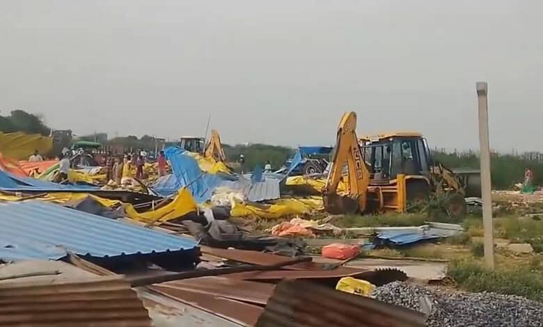 Demolition of huts in Hanamkonda during anti-encroachment drive with excavators and debris.