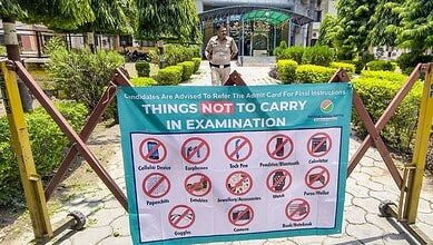 Signboard listing items not allowed in examination, including cellphones and smartwatches.