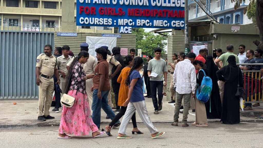 Students and parents gather outside a college for NEET exam registration or results.