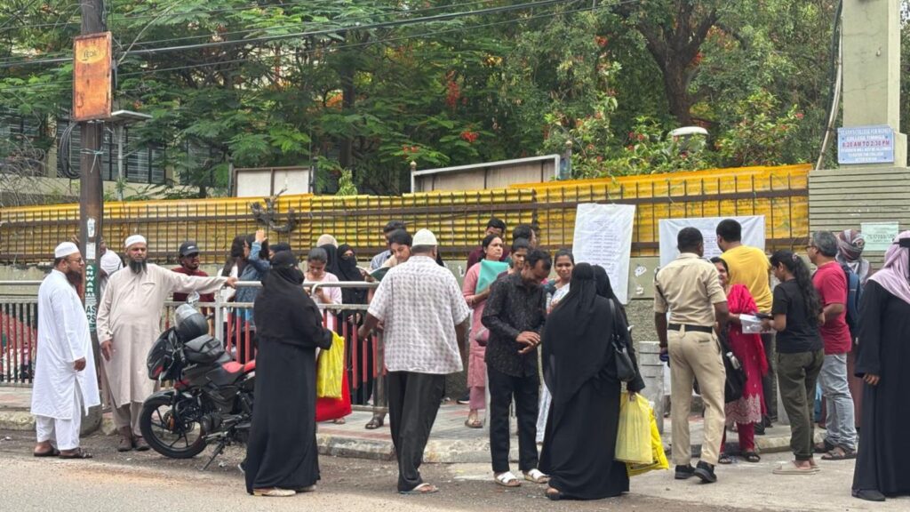 Parents and students waiting outside exam centre during NEET exam in India.
