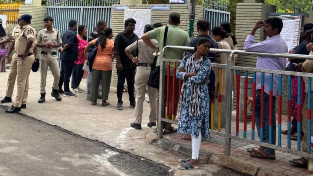 Students and police officers outside an exam centre during NEET exam day.