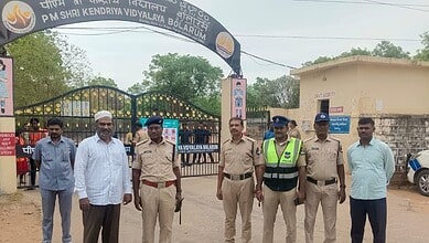 Group of police officers and officials standing outside PM Shri Kendriya Vidyalaya school in Bolarum.