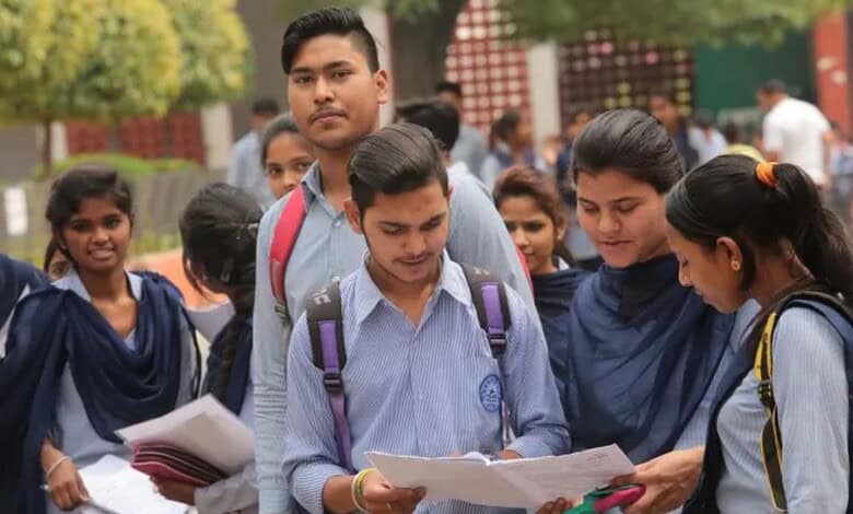 Students in school uniforms reading and discussing exam results outdoors.