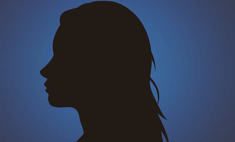 Silhouette of a woman with long hair against a blue background.