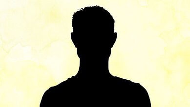 Silhouette of a man against a yellow background, no facial features visible.