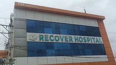 Recovery Hospital building with blue glass windows and orange accents in Hyderabad.