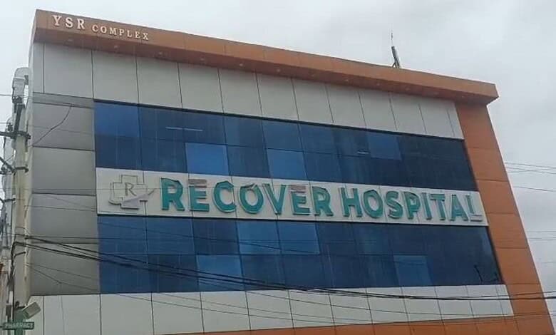 Recovery Hospital building with blue glass windows and orange accents in Hyderabad.