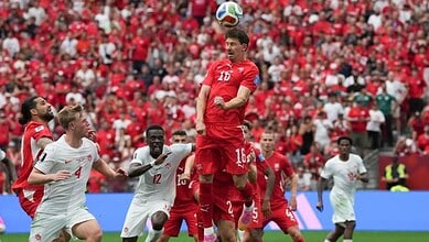 Canada and Switzerland players jostle for the ball