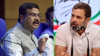 Two Indian politicians speaking at a press conference, one gesturing with his hand.