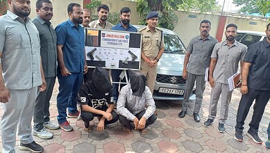Police and officials display seized bullets and weapons in Hyderabad.