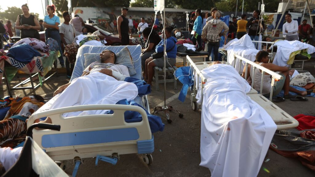 Patients lying on hospital beds and stretchers after the Venezuela earthquake, with medical staff and on-.