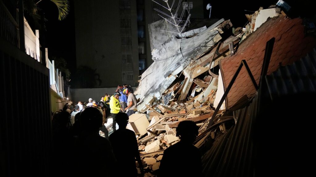 Rescue workers and onlookers at the site of a collapsed building after the Venezuela earthquake.