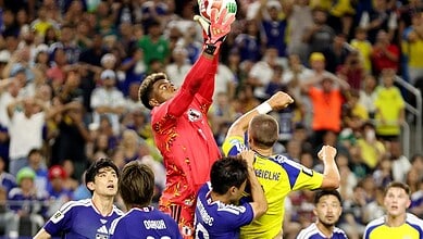 Japanese goalkeeper catches the ball
