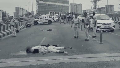 Road accident scene in Hyderabad's Gachibowli with injured person lying on the road.
