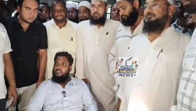 Group of men, including a seated man, gathered in a room during a protest or incident.