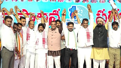 Group of politicians celebrating with raised hands at a political event in India.