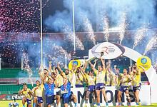 Hyderabad Heroes celebrate winning Rugby Premier League with fireworks and trophy in stadium.