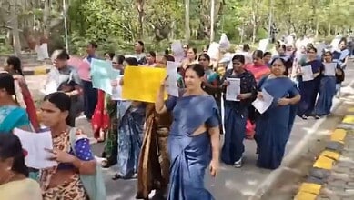 Contract workers at University of Hyderabad protest labour laws with placards and banners.